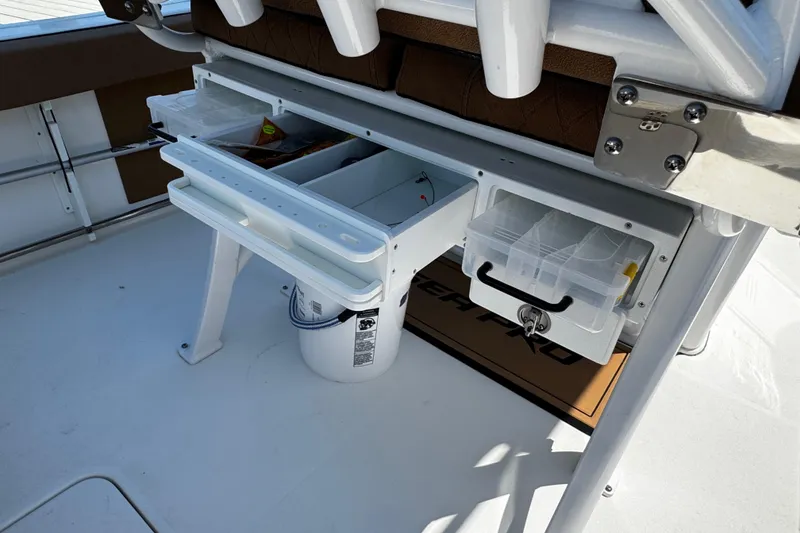 Slide: The Image of 2024 Sea Pro 239 Deep V CC boat with organized storage compartments and fishing gear. - 64