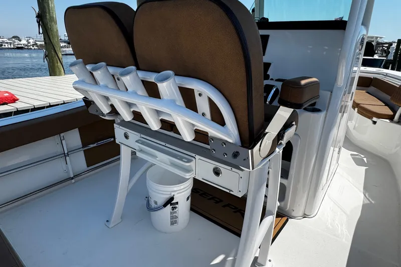 Slide: The Image of 2024 Sea Pro 239 Deep V CC boat interior with rod holders and seating. - 65