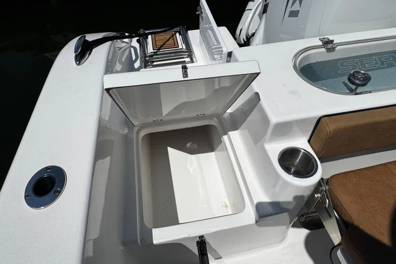 Slide: The Image of 2024 Sea Pro 239 Deep V CC boat interior with storage compartment and cup holder. - 66