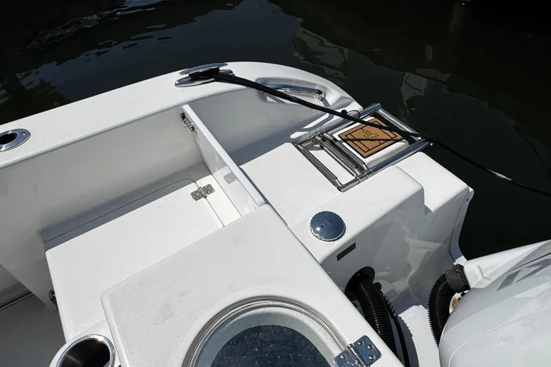 Slide: The Image of 2024 Sea Pro 239 Deep V CC boat deck with storage and motor details. - 68