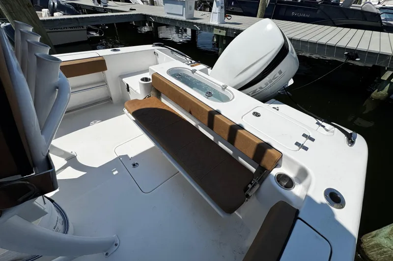 Slide: The Image of 2024 Sea Pro 239 Deep V CC boat interior with seating and Suzuki outboard motor. - 72