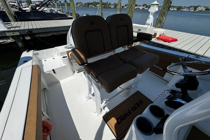 Slide: The Image of 2024 Sea Pro 239 Deep V CC boat interior with dual seats and steering wheel. - 74