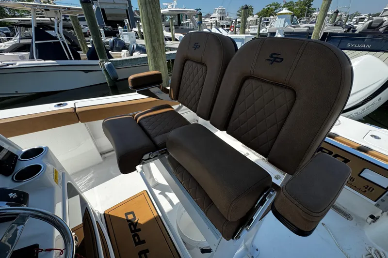 Slide: The Image of 2024 Sea Pro 239 Deep V CC boat with luxurious brown seating and sleek design. - 76
