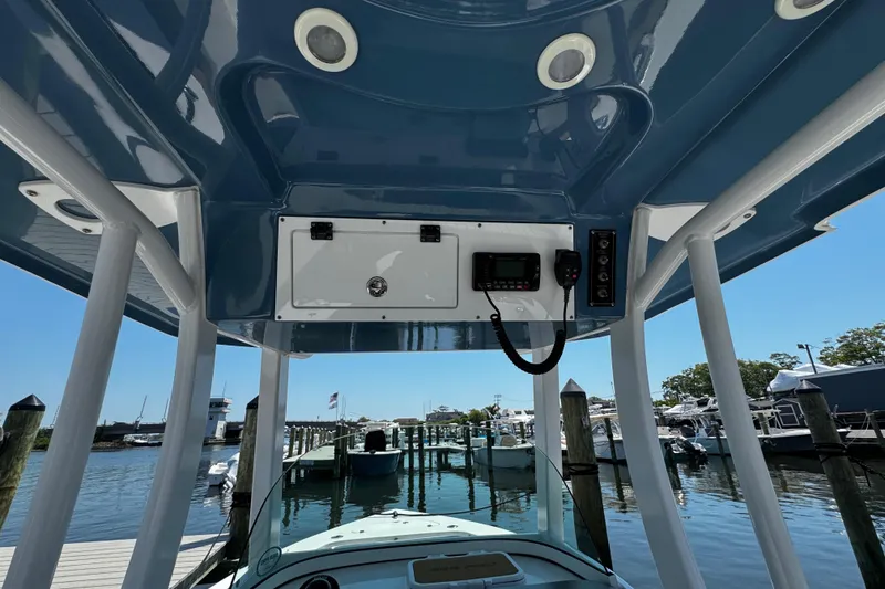 Slide: The Image of 2024 Sea Pro 239 Deep V CC boat console with electronics, docked at marina. - 86