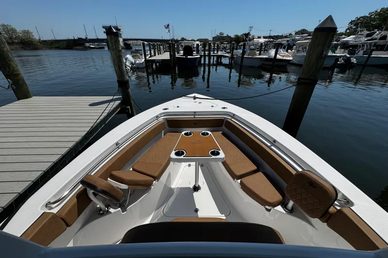 Slide: The Image of 2024 Sea Pro 239 Deep V CC boat docked, featuring spacious seating and sleek design. - 87