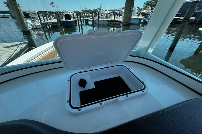 Slide: The Image of Open storage compartment on 2024 Sea Pro 239 Deep V CC boat at marina. - 88