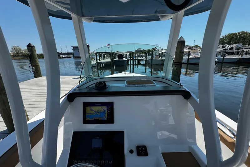 Slide: The Image of 2024 Sea Pro 239 Deep V CC boat dashboard with navigation system at marina. - 90