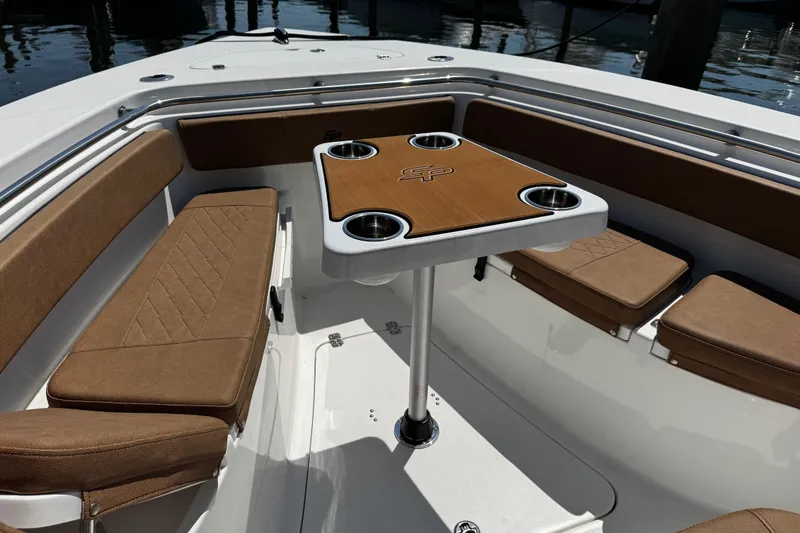 Slide: The Image of 2024 Sea Pro 239 Deep V CC boat interior with cushioned seating and table. - 91