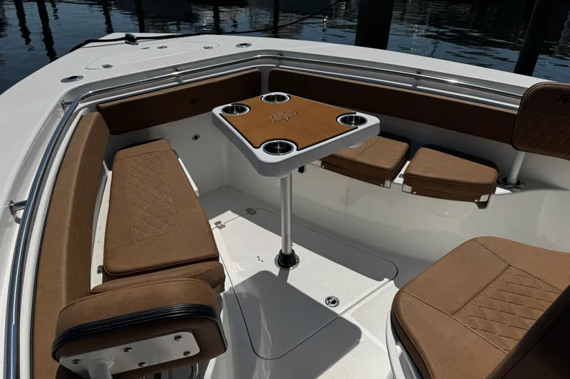 Slide: The Image of 2024 Sea Pro 239 Deep V CC boat interior with brown seating and table. - 92