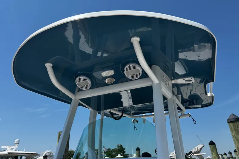 Slide: The Image of 2024 Sea Pro 239 Deep V CC boat with sleek T-top design under clear blue sky. - 94