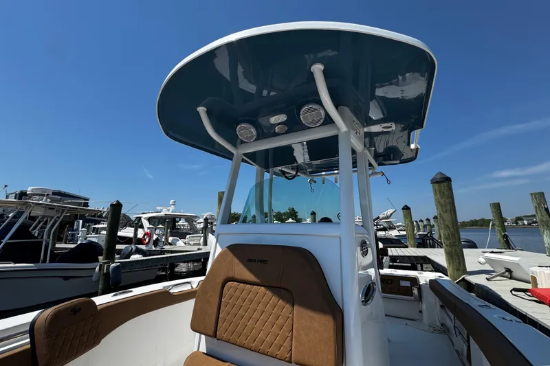 Slide: The Image of 2024 Sea Pro 239 Deep V CC boat docked, featuring a sleek design and spacious seating. - 95