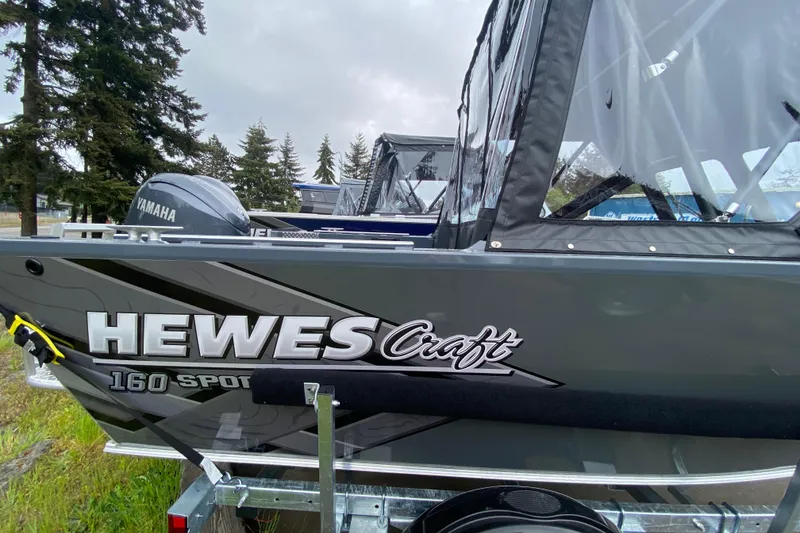 Slide: The Image of 2026 Hewescraft 160 Sportsman boat with Yamaha engine, parked outdoors. - 3