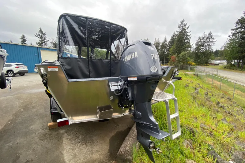Slide: The Image of 2026 Hewescraft 160 Sportsman boat with Yamaha 70 outboard motor, parked outdoors. - 4