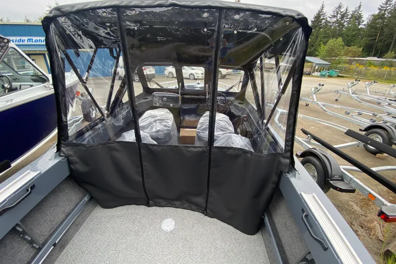Slide: The Image of 2026 Hewescraft 160 Sportsman boat with protective canopy and clear windows. - 7