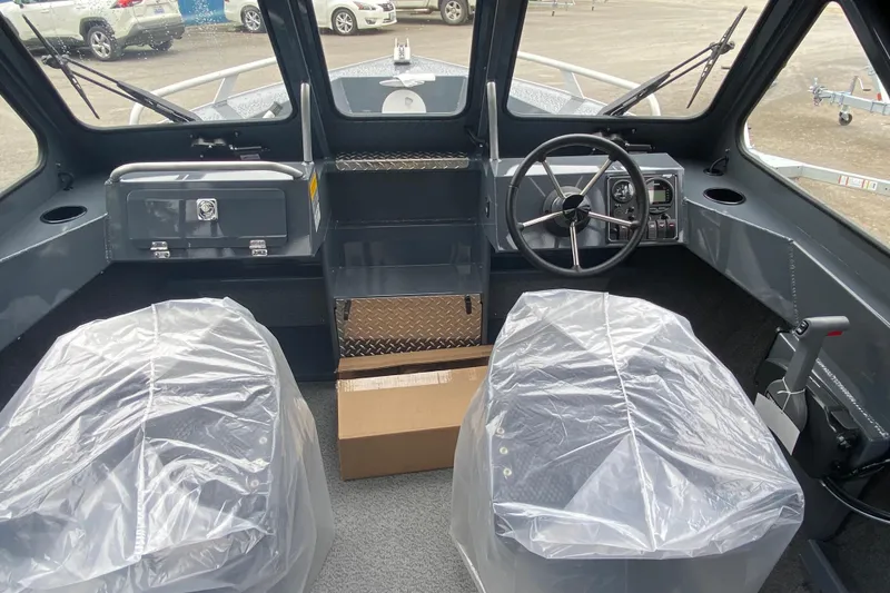 Slide: The Image of Interior of 2026 Hewescraft 160 Sportsman boat with covered seats and steering wheel. - 8