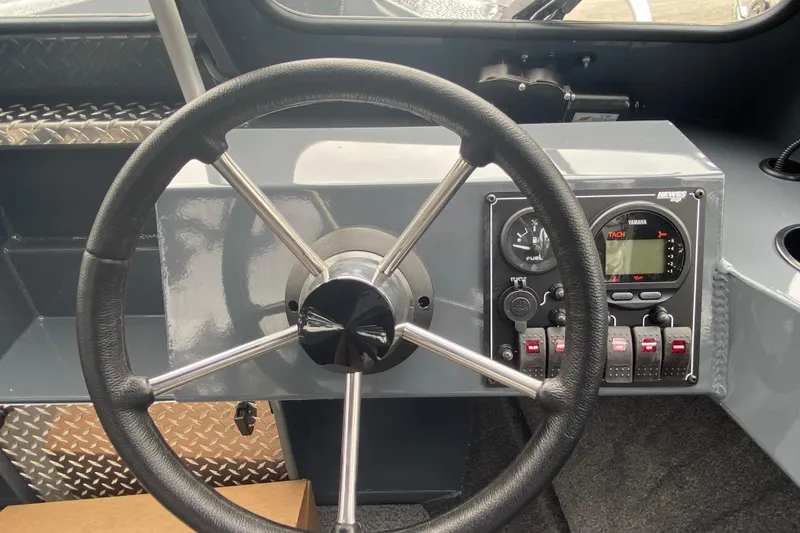 Slide: The Image of 2026 Hewescraft 160 Sportsman dashboard with steering wheel and control panel. - 9
