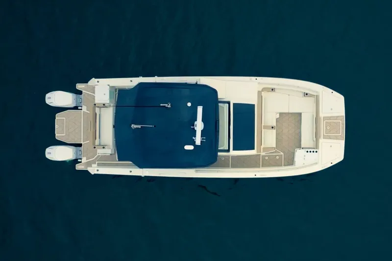 Slide: The Image of Aerial view of a 2027 Ducari 37 XIV on calm water, featuring dual outboard engines. - 19