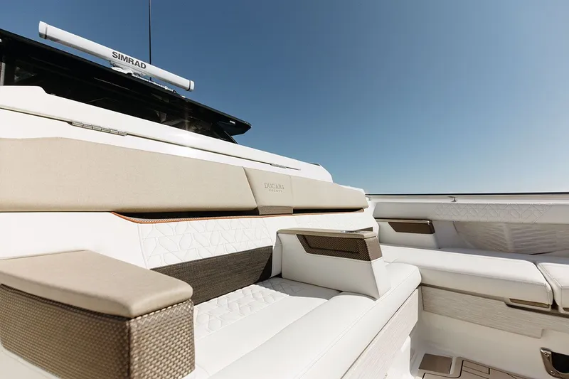 Slide: The Image of Luxurious seating area on a modern yacht with beige and white upholstery, under clear skies. - 8
