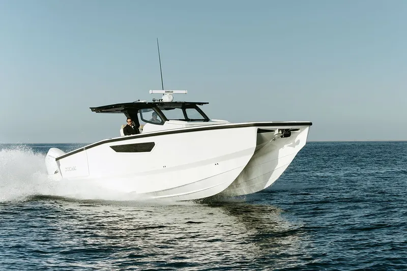 Slide: The Image of A modern white catamaran boat speeds across the calm sea. - 0