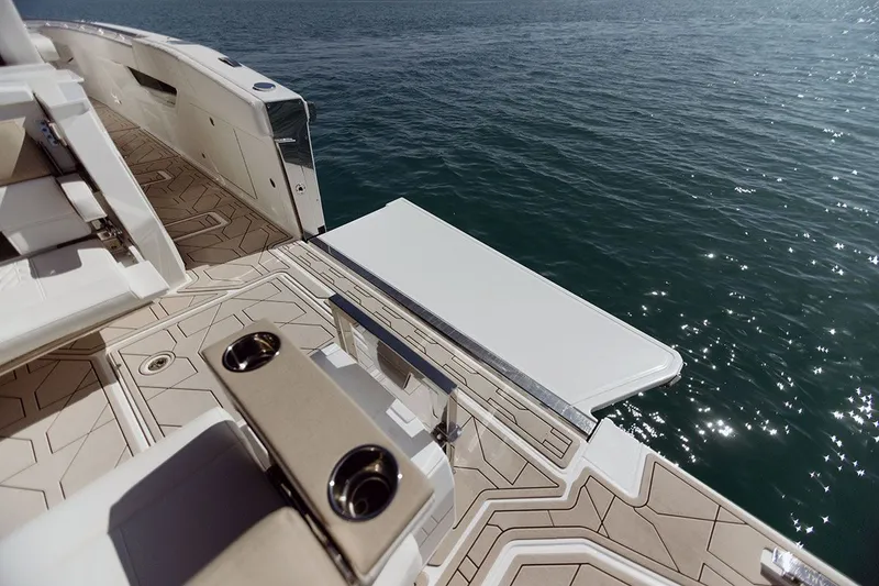 Slide: The Image of The image shows the deck of a 2027 Ducari 37 XIV boat with sleek seating and a table. - 3