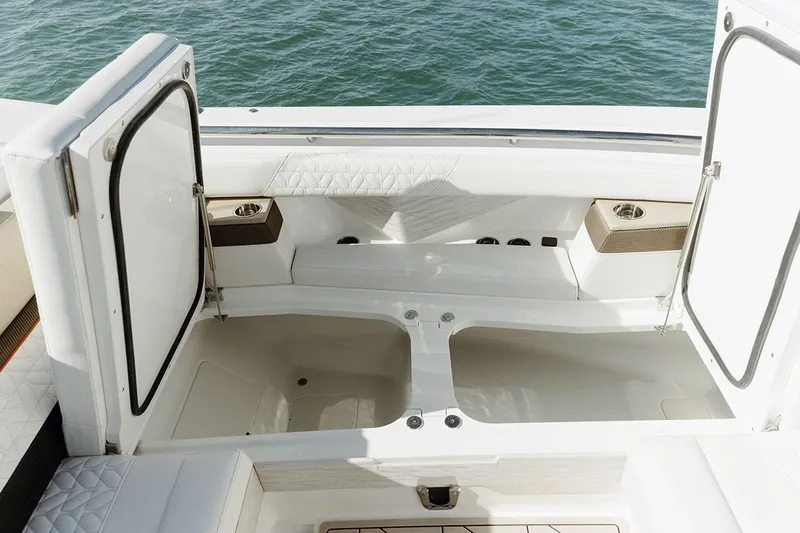Slide: The Image of The image shows the stern of a 2027 Ducari 37 XIV boat with open storage compartments. - 14