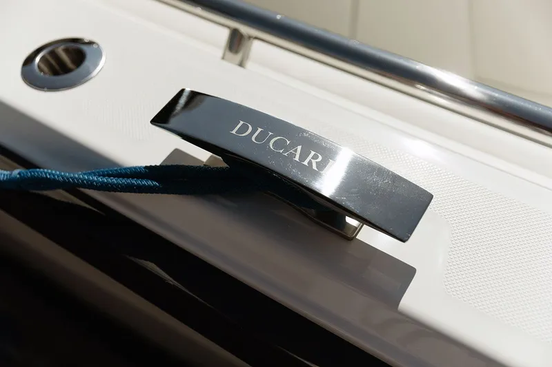 Slide: The Image of Close-up of a shiny metal handle with "DUCARI" inscribed on a boat. - 2