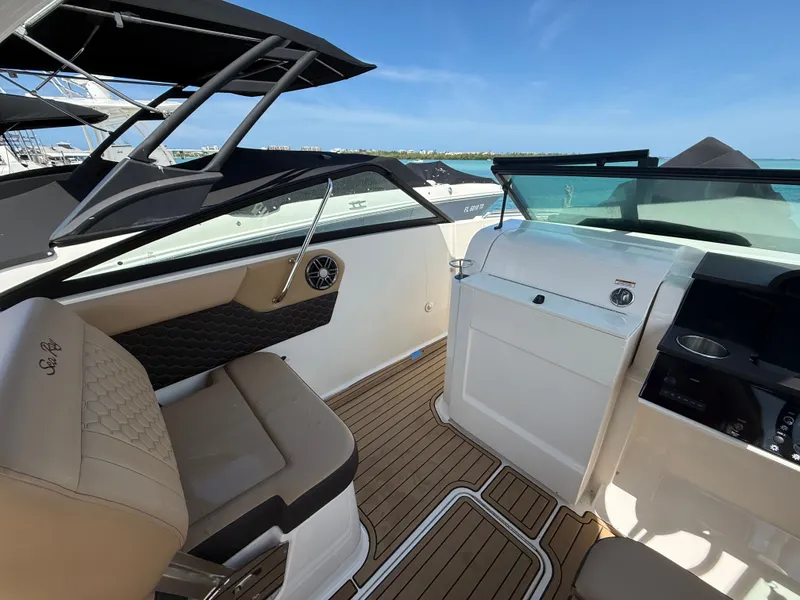 Slide: The Image of Interior of a 2023 Sea Ray SDX 250 Outboard with beige seating. - 15