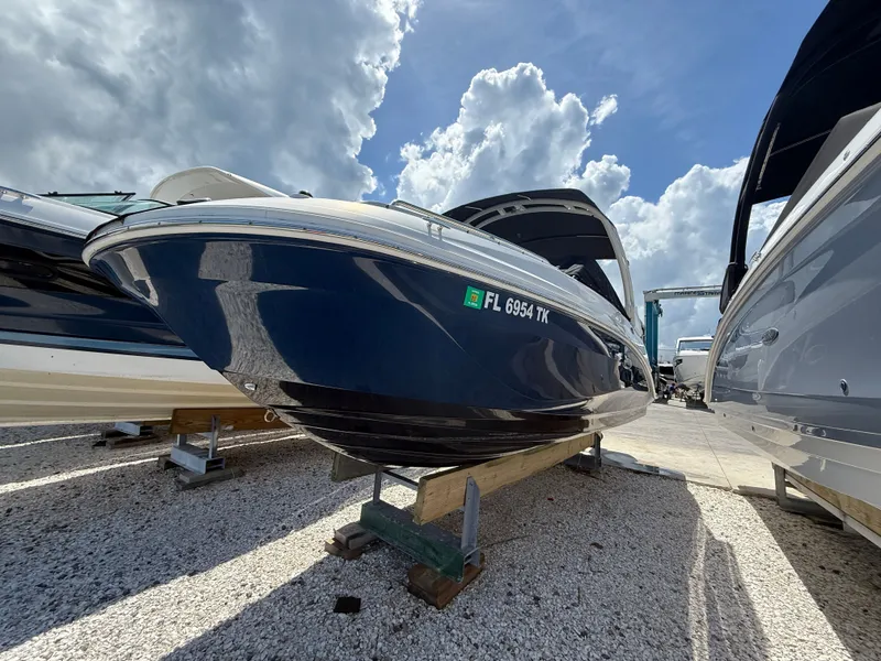 Slide: The Image of 2023 Sea Ray SDX 250 Outboard on gravel, under cloudy sky. - 4