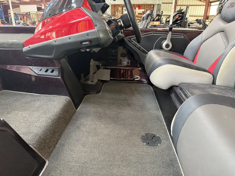 Slide: The Image of 2017 Skeeter ZX225 boat interior with steering and seating. - 13