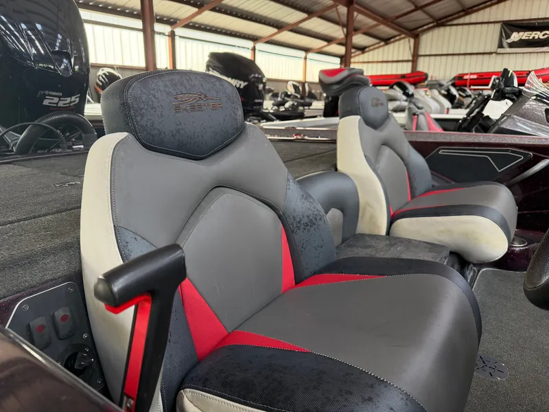 Slide: The Image of Interior of a 2017 Skeeter ZX225 boat with gray and red seats. - 15