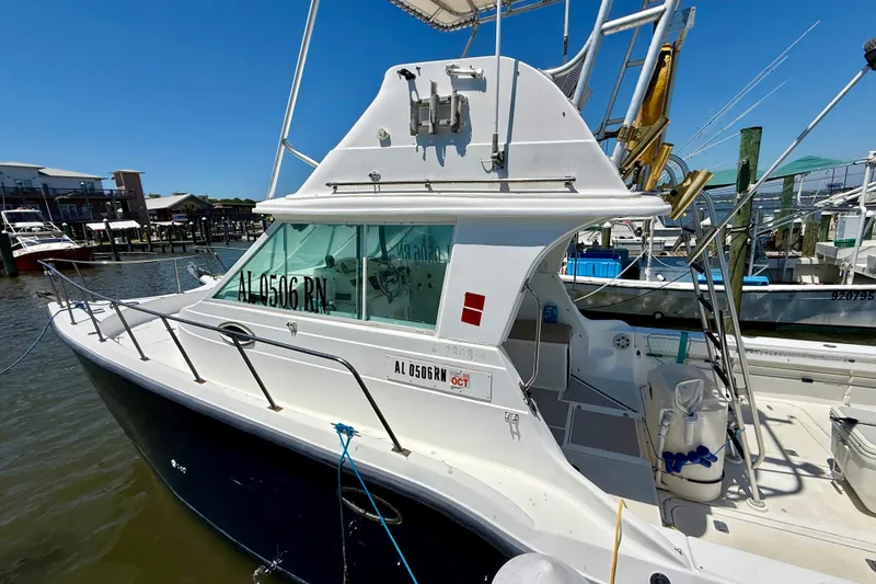 Slide: The Image of 2000 BAJA CRUISER King Cat 340 docked at marina under clear blue sky. - 10