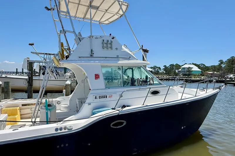 Slide: The Image of 2000 BAJA CRUISER King Cat 340 docked at marina under clear blue sky. - 11