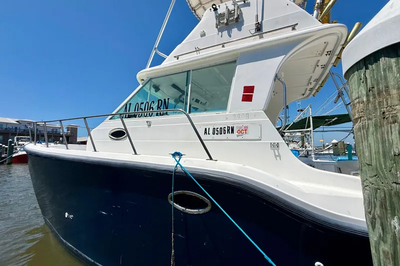 Slide: The Image of 2000 BAJA CRUISER King Cat 340 docked at marina, side view. - 12