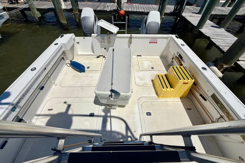 Slide: The Image of Open deck of a 2000 BAJA CRUISER King Cat 340 at a marina. - 16