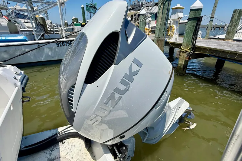 Slide: The Image of Outboard motor on a 2000 BAJA CRUISER King Cat 340 at a marina dock. - 19