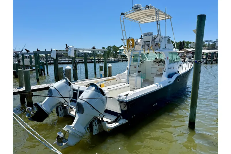 Slide: The Image of 2000 BAJA CRUISER King Cat 340 docked with dual outboard motors. - 2