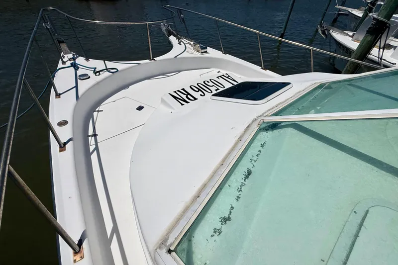 Slide: The Image of 2000 BAJA CRUISER King Cat 340 boat docked, featuring sleek white deck and railing. - 20