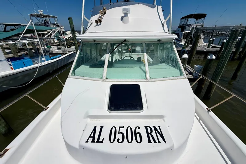 Slide: The Image of White 2000 BAJA CRUISER King Cat 340 boat docked, displaying registration number AL 0506 RN. - 23