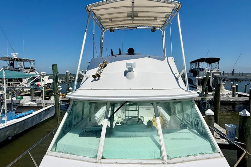 Slide: The Image of 2000 BAJA CRUISER King Cat 340 docked at marina under clear blue sky. - 24