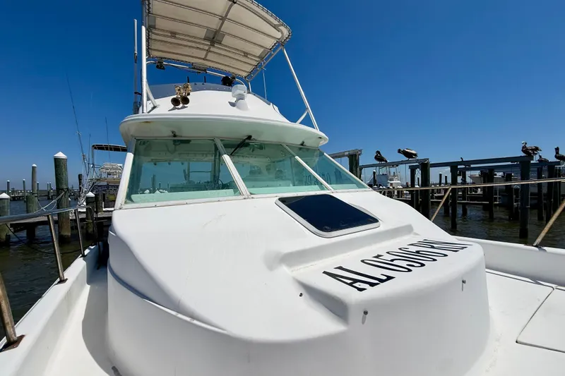 Slide: The Image of 2000 BAJA CRUISER King Cat 340 docked at marina under clear blue sky. - 25