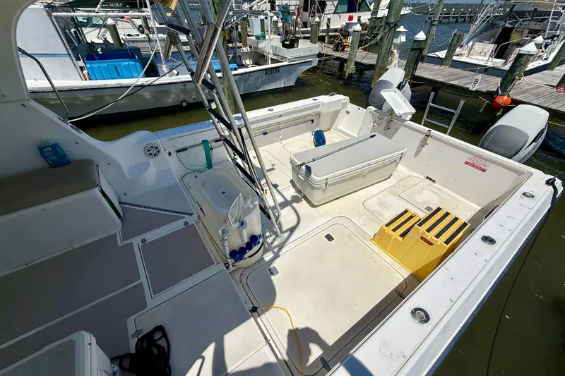 Slide: The Image of 2000 BAJA CRUISER King Cat 340 boat deck with storage and fishing equipment. - 28