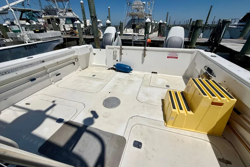 Slide: The Image of Open deck of a 2000 BAJA CRUISER King Cat 340 at a marina. - 30