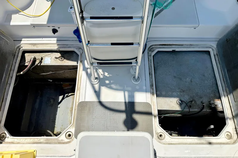 Slide: The Image of Open compartments on a 2000 BAJA CRUISER King Cat 340 boat deck. - 33