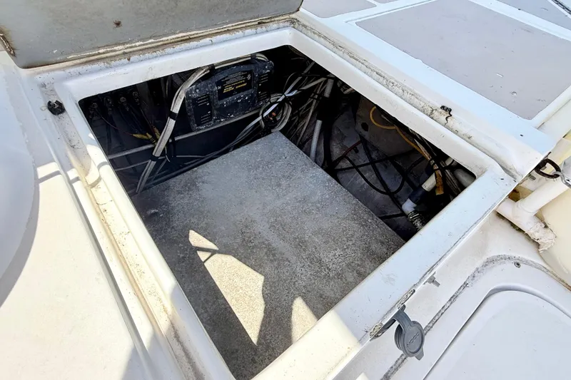 Slide: The Image of Open hatch of a 2000 BAJA CRUISER King Cat 340, revealing internal wiring and components. - 37