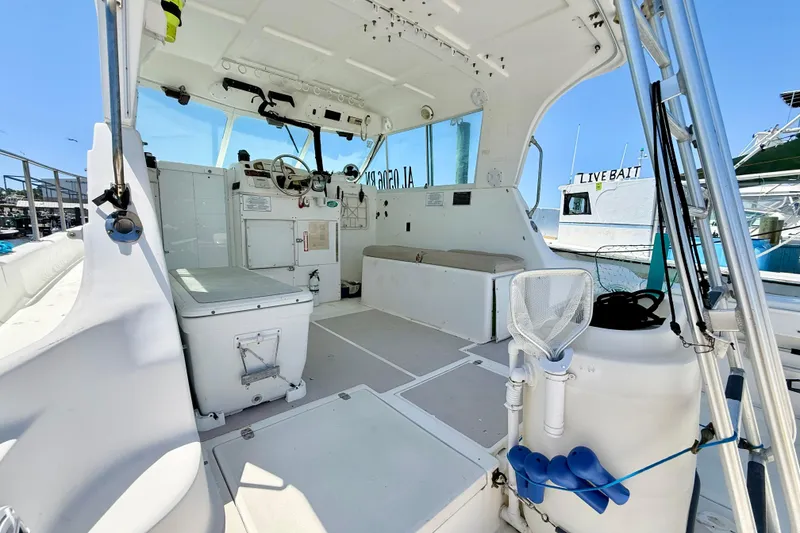 Slide: The Image of Interior of a 2000 BAJA CRUISER King Cat 340 boat, featuring helm and seating area. - 39