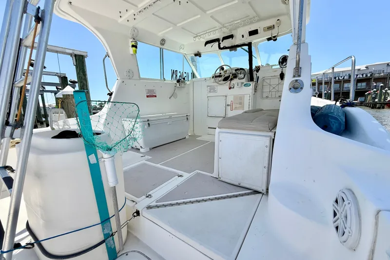 Slide: The Image of Interior view of a 2000 BAJA CRUISER King Cat 340 boat, featuring seating and fishing equipment. - 40