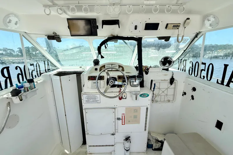 Slide: The Image of Interior of a 2000 BAJA CRUISER King Cat 340 boat cockpit with steering wheel and controls. - 44