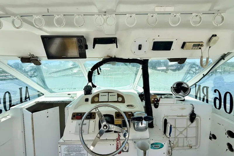 Slide: The Image of Cockpit of 2000 BAJA CRUISER King Cat 340 with steering wheel and navigation equipment. - 45