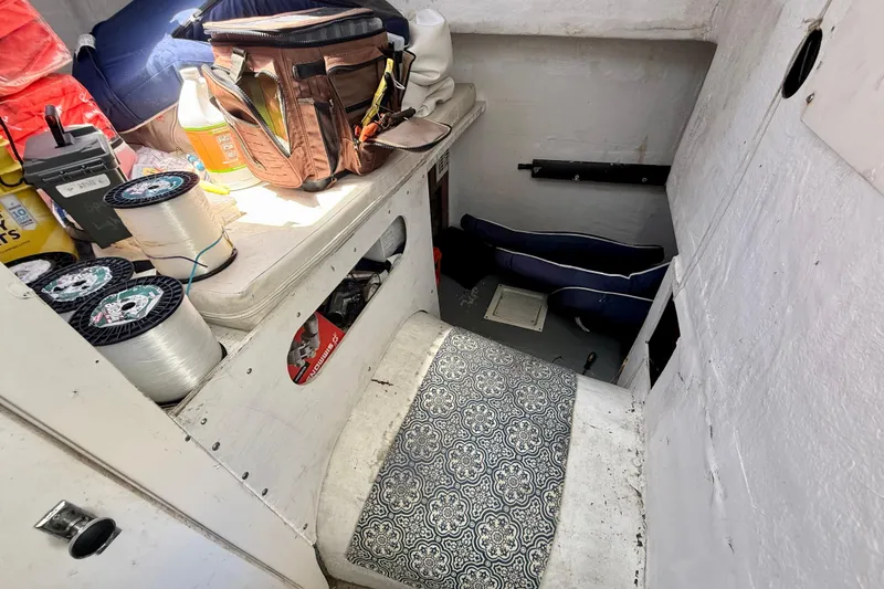 Slide: The Image of Interior of a 2000 BAJA CRUISER King Cat 340 with fishing gear and supplies. - 52