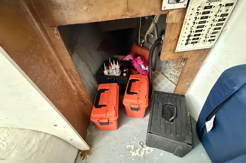 Slide: The Image of Storage area in a 2000 BAJA CRUISER King Cat 340 with toolboxes and supplies. - 53